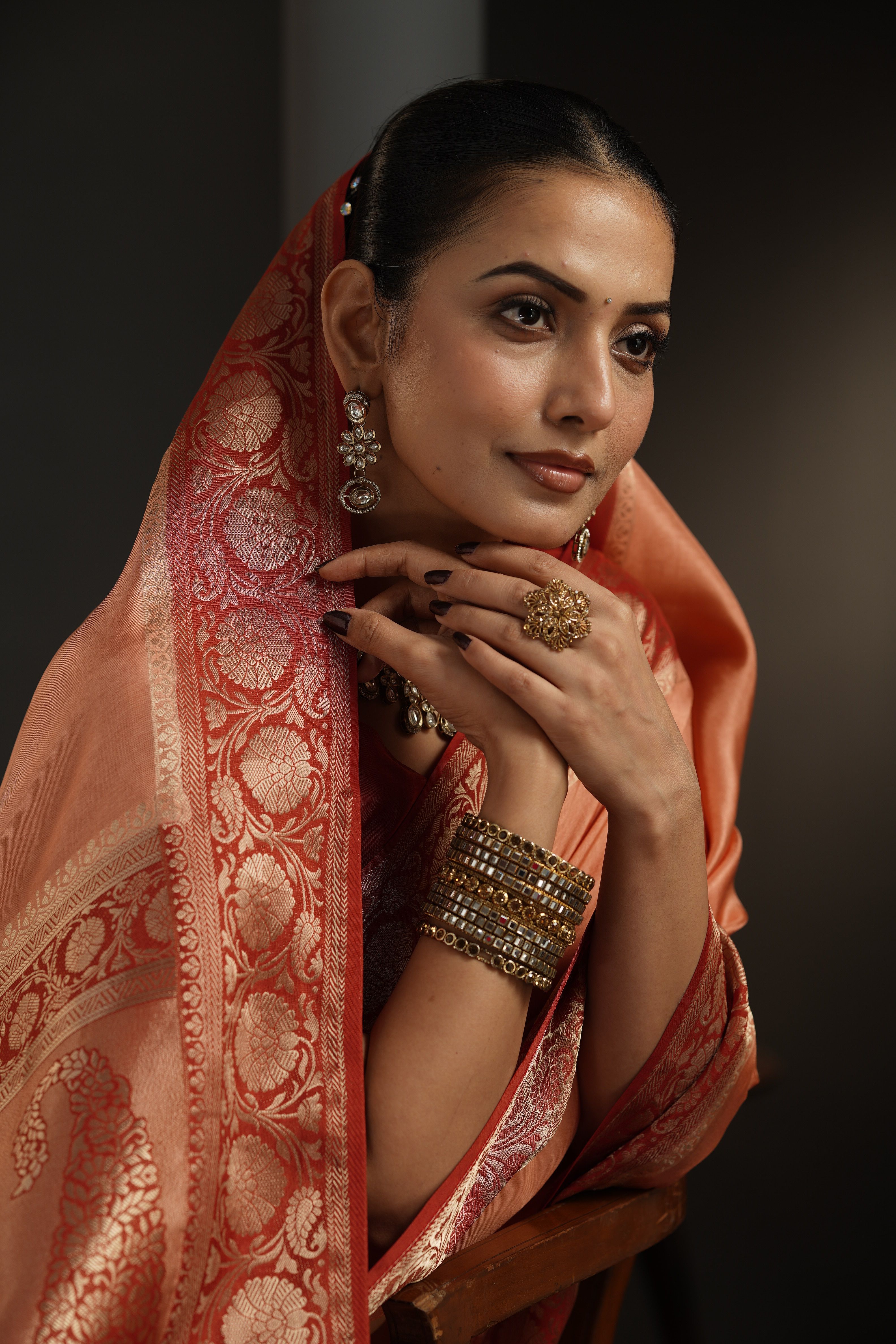 Model wearing a midnight blue saree with a vermilion border