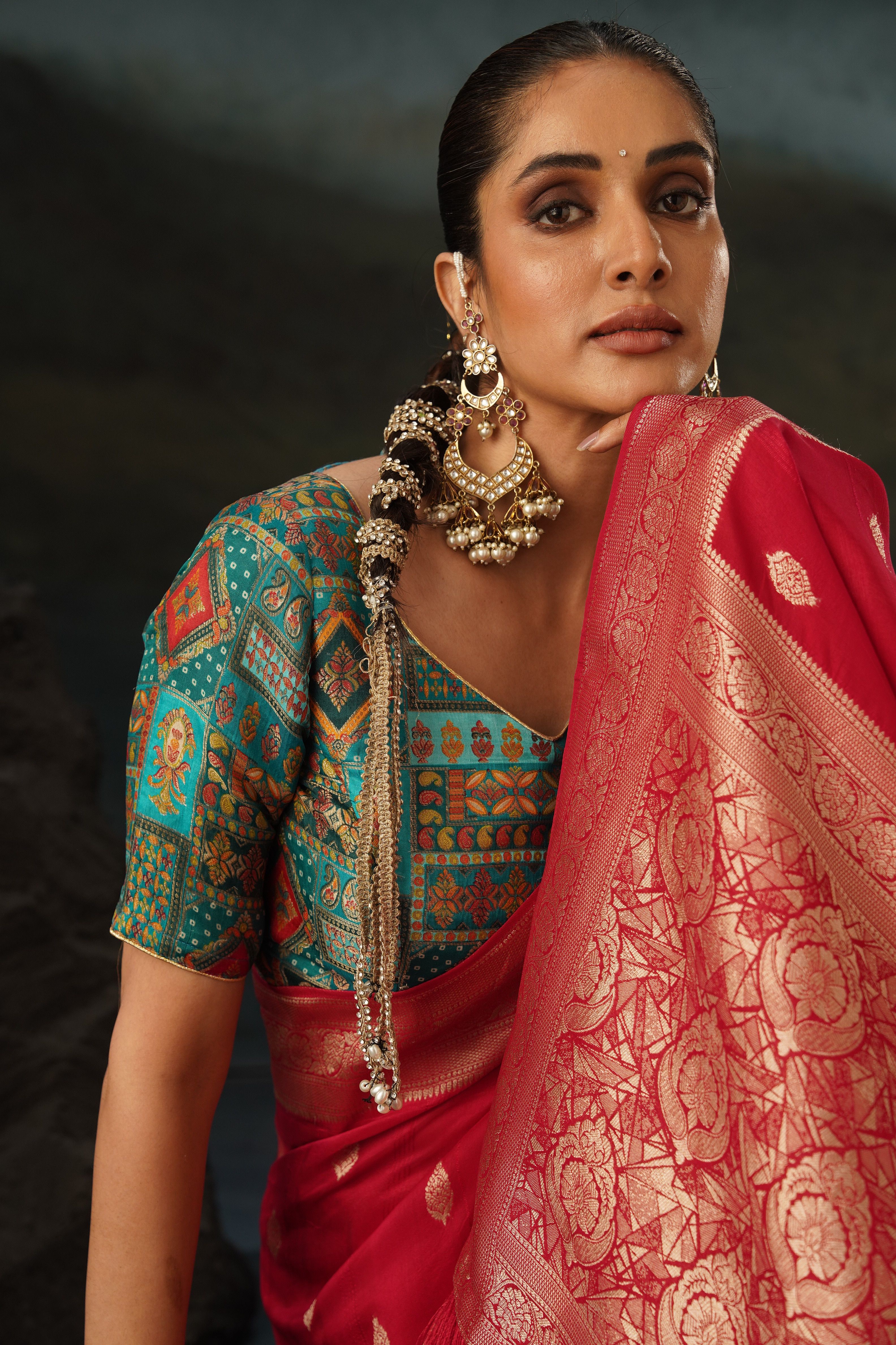 Model wearing an aqua blue saree with a dark woven border
